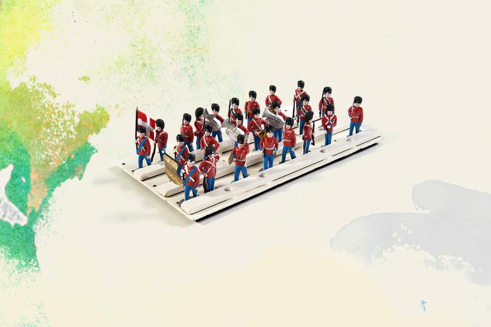 three rows of toy soldiers in red and blue uniforms