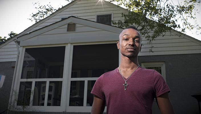 Tavon Vinson stands in front of his Baltimore home