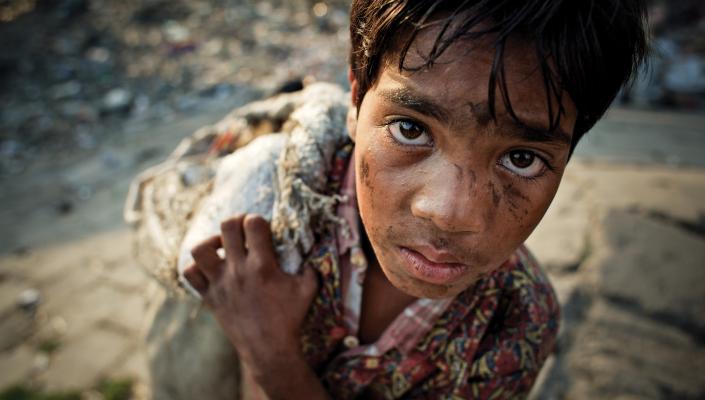 12 year-old-boy scavenging in Bangladesh.