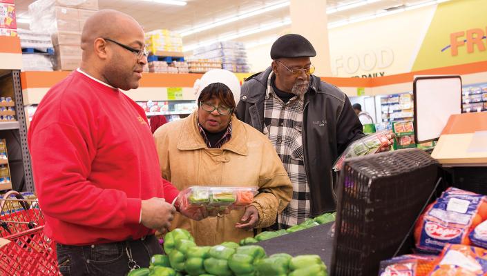 Theodora and Eugene Morris (married for 45 years) discuss the bell peppers with Food Depot produce manager Dominic Wilson.