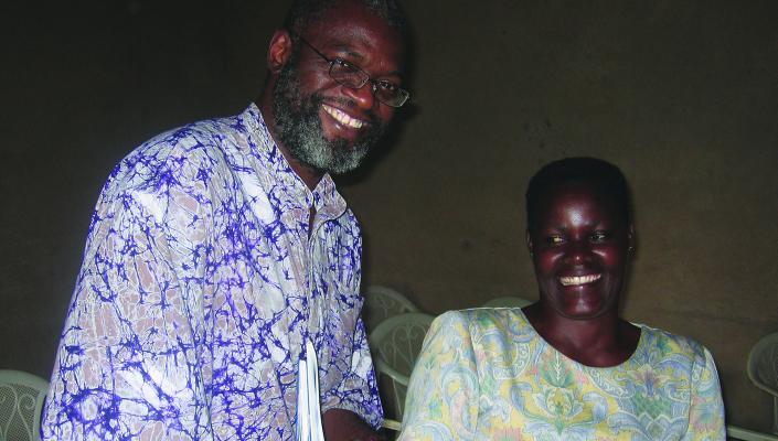Nosa Orobaton and a Ugandan community medicine distributor