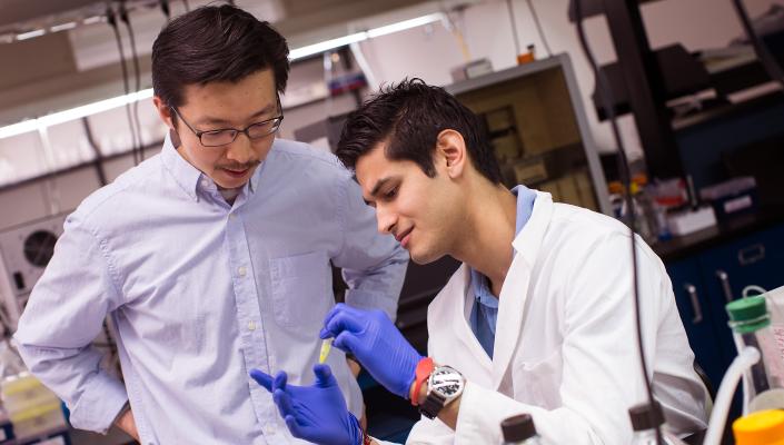 Jiou Wang and a student in his lab