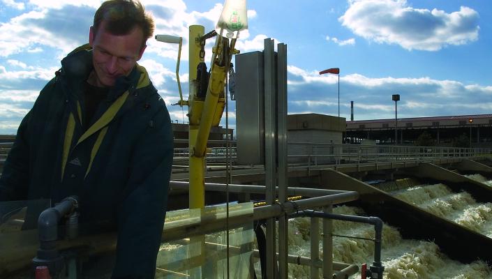 Rolf Halden takes a water sample at a treatment plant