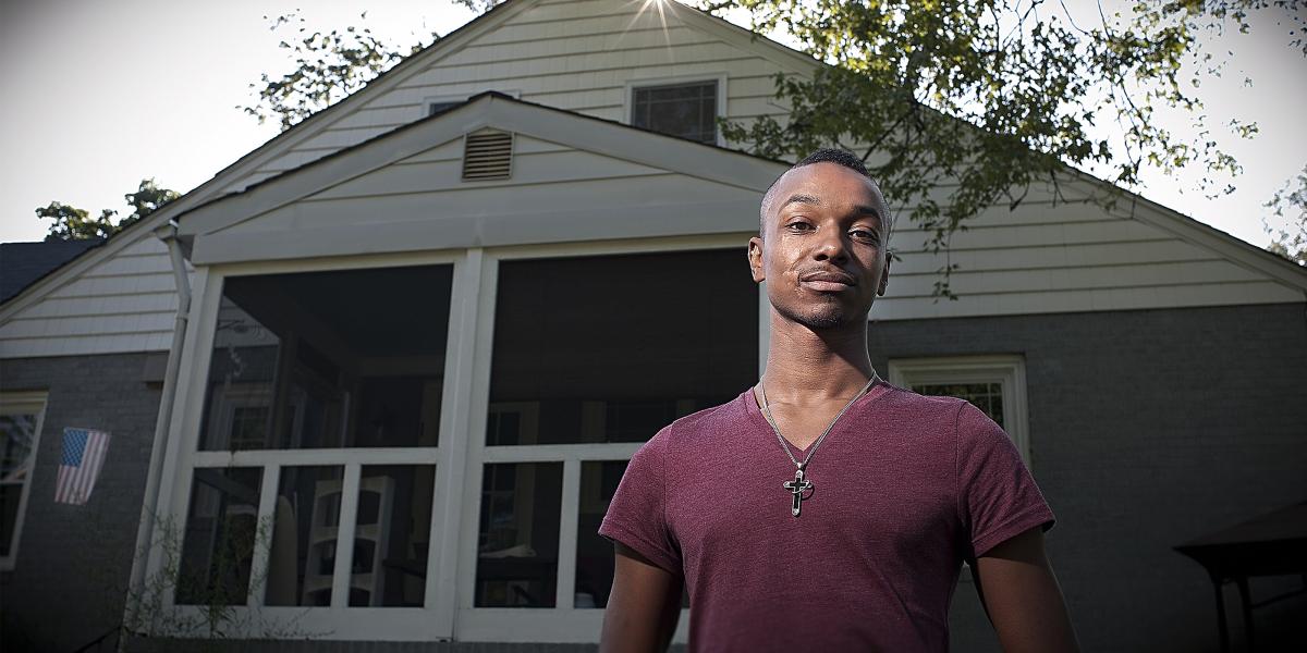 Tavon Vinson stands in front of his Baltimore home