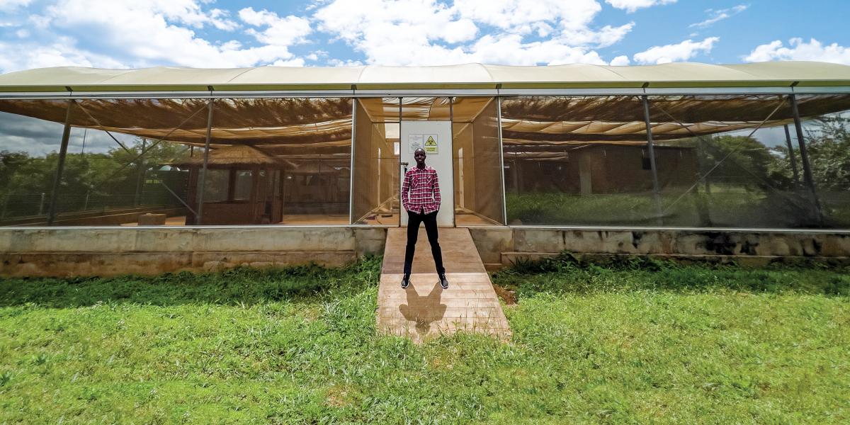 Entomologist Limonty Simubali stands in front of the “mosquito house” in Macha, Zambia, on March 30, 2022.