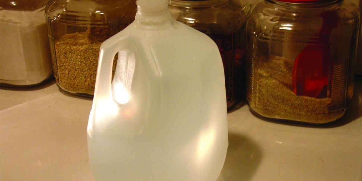 a gallon bottle of water and canisters of rice and other staples