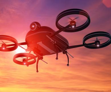 illustration of a drone flying against a sunset sky