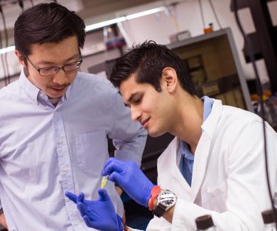 Jiou Wang and a student in his lab
