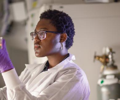 Gifty Atanga inspects a culture in MMI Professor Andy Pekosz's lab.